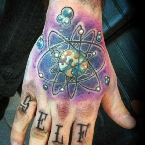 Colored vintage style hand tattoo of atom with planet