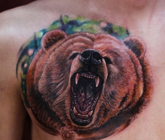 Colorful bear head tattoo on shoulder blade