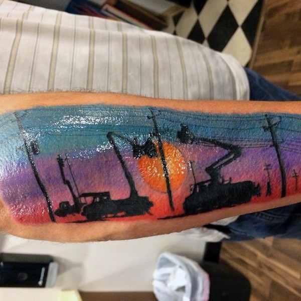 Colorful beautiful looking arm tattoo of linemen working with sunset