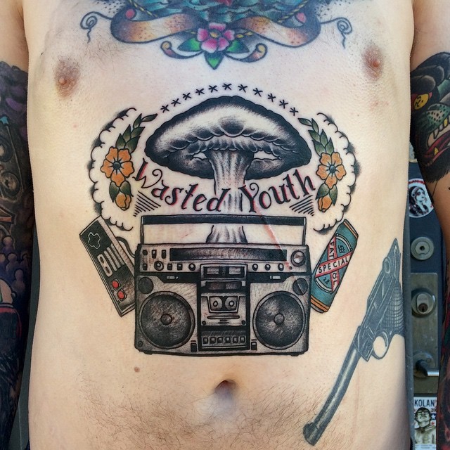 Colorful belly tattoo of music set with lettering and flowers