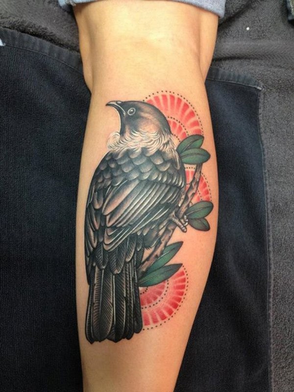 Colorful bird on branch forearm tattoo