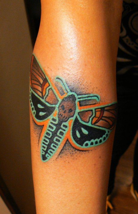 Colorful bug dead head tattoo on arm