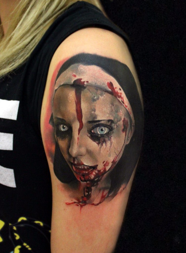 Colorful creepy looking shoulder tattoo of bloody woman