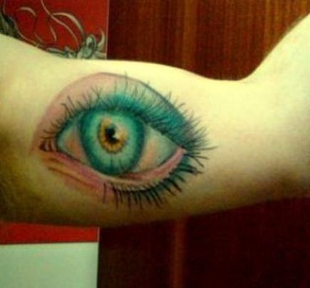 Colorful eye tattoo on arm