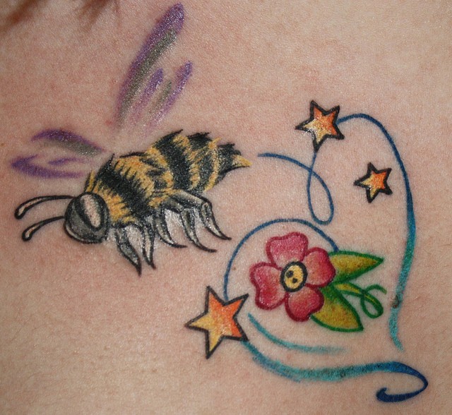 Colorful flower with bee tattoo