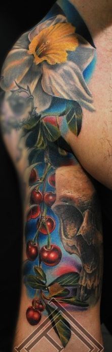 Colorful flowers with cherry tattoo on arm