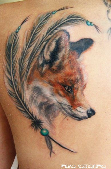 Colorful fox head and charm of feathers tattoo
