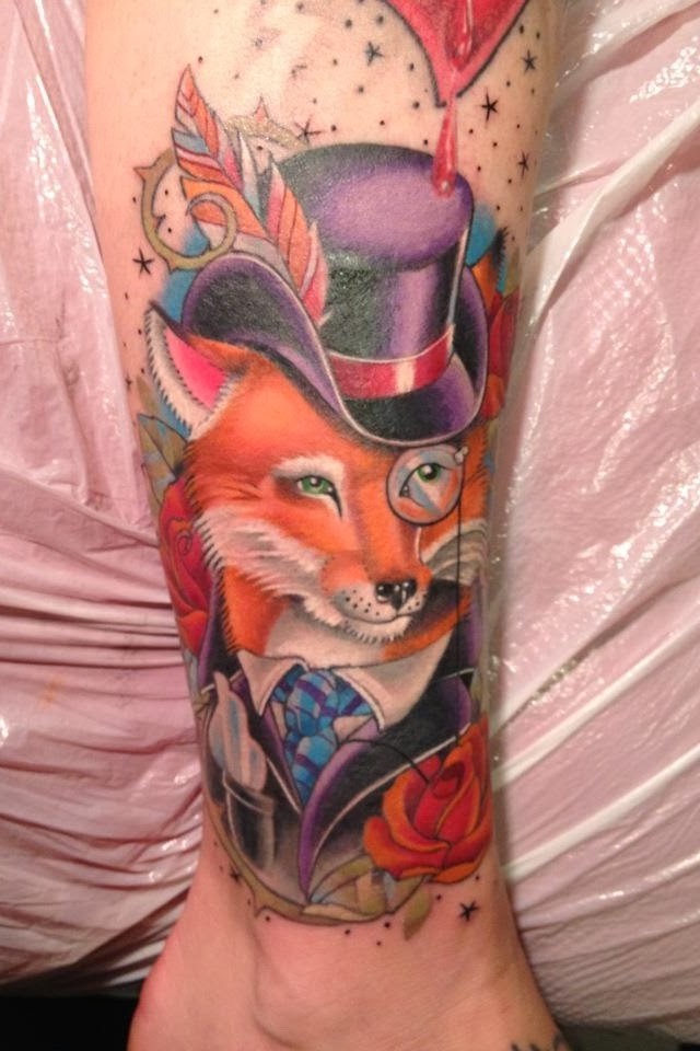 Colorful fox in a hat and prince tattoo on leg