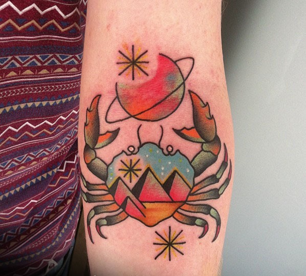 Colorful galaxy crab tattoo on forearm