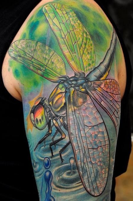 Colorful dragonfly tattoo on arm for men
