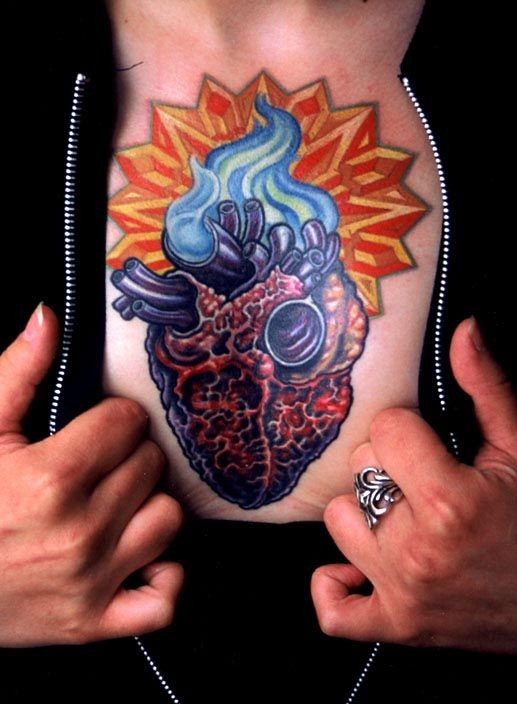Colorful heart tattoo on chest by Mike Cole