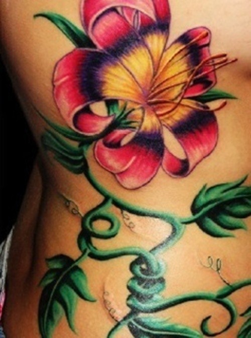 Colorful hibiscus flower tattoo on ribs