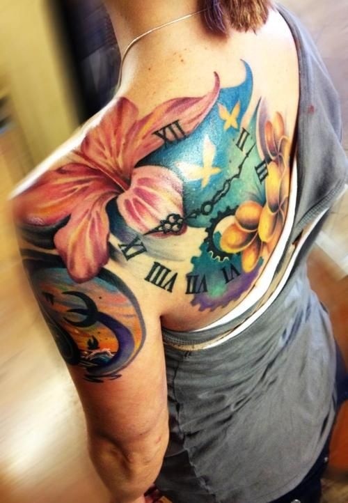 Colorful hibiscus flowers and watch tattoo on shoulder blade