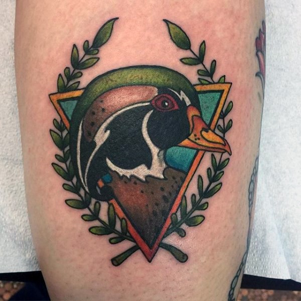 Colorful leg tattoo of wild bird and triangle