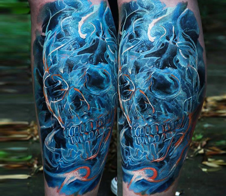 Colorful mystical looking leg tattoo of smoke like skull