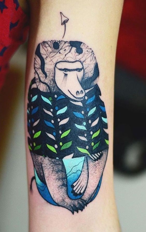 Colorful psychedelic looking arm tattoo of funny monkey