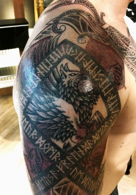 Colorful shoulder tattoo of ancient lettering with eagle