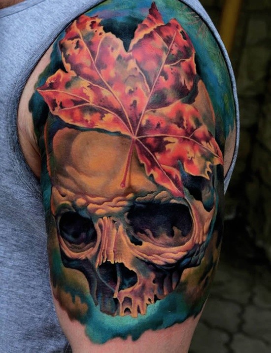 Colorful skull and a maple leaf tattoo on half sleeve