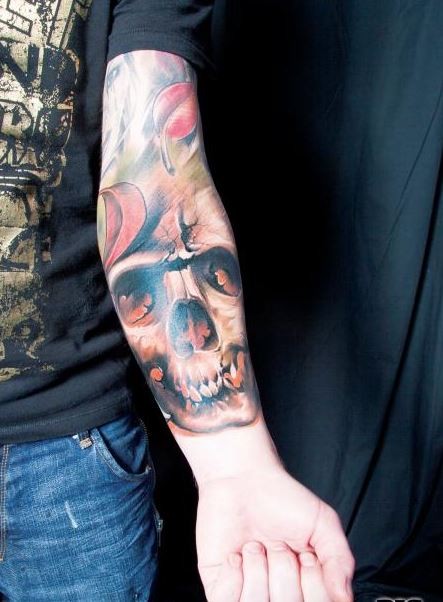 Colorful skull with falling leaves forearm tattoo