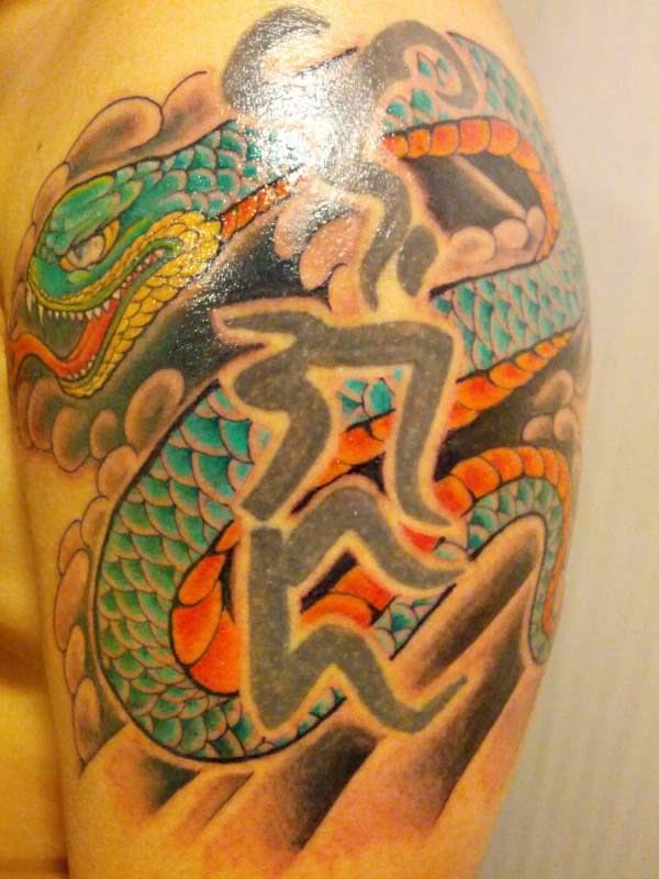 Colorful snake and hieroglyphs tattoo