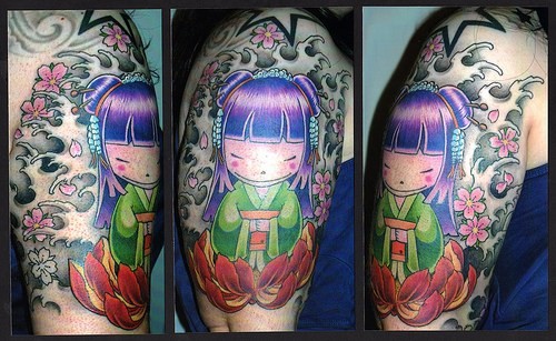 Colorful tattoo on hand with chinese girl and lotos