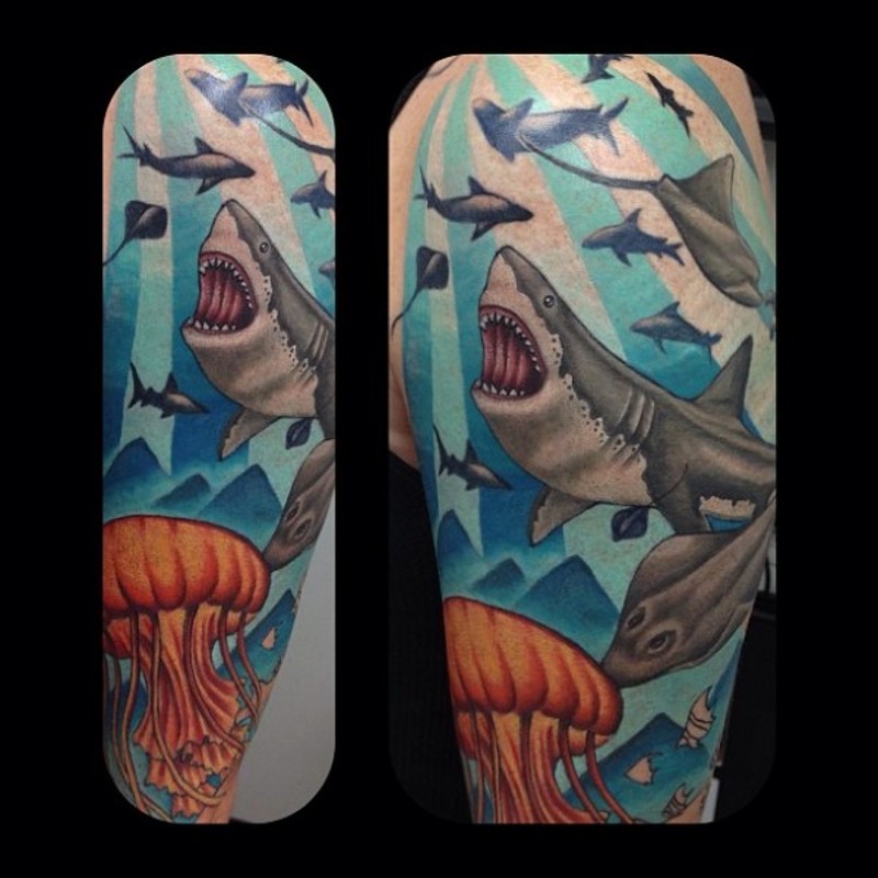 Colorful underwater life tattoo on shoulder stylized with sharks and jellyfish