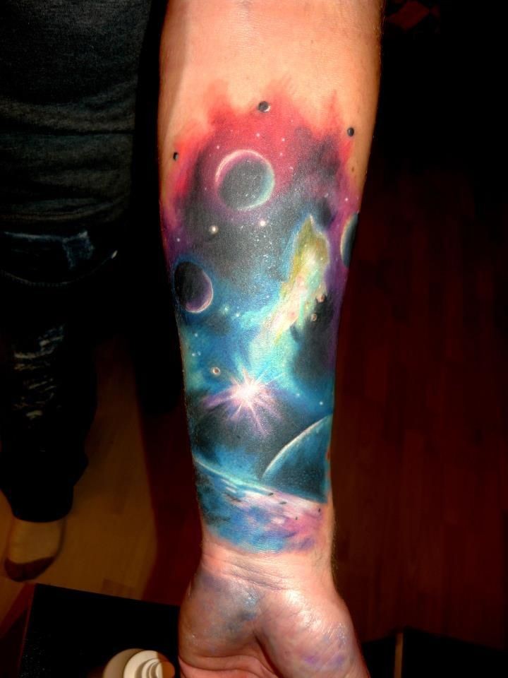 Colorful watercolor planets in space forearm tattoo - Tattooimages.biz