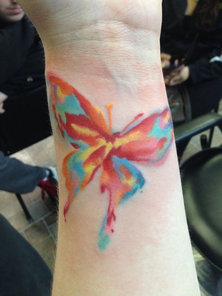 Colorful watercolor tattoo on arm for girls