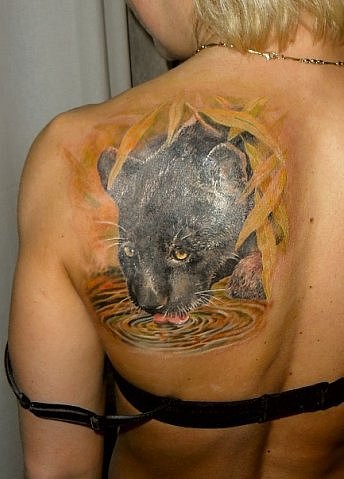Coloured black panther drinking water tattoo on shoulder blade