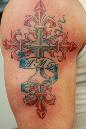 Coloured fleur de lis cross with initials tattoo on shoulder