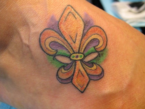 Coloured fleur de lis tattoo on foot