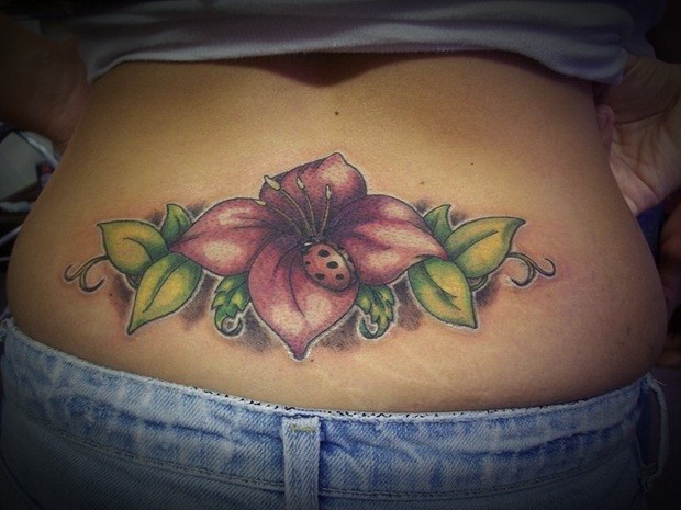 Coloured flower tattoo on lower back