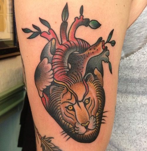 Coloured heart of a lion tattoo by Paul Dobleman