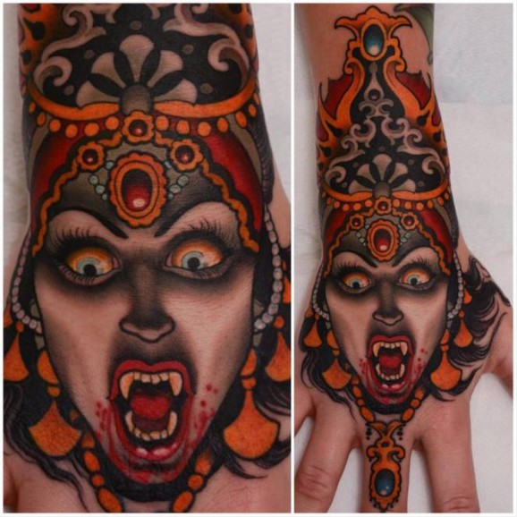 Coloured old school vampiress tattoo on hand by Peter Lagergren