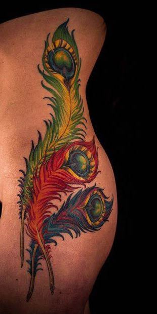 Coloured peacock feathers tattoo on ribs