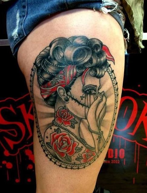 Coloured portrait of santa muerte girl tattoo on thigh
