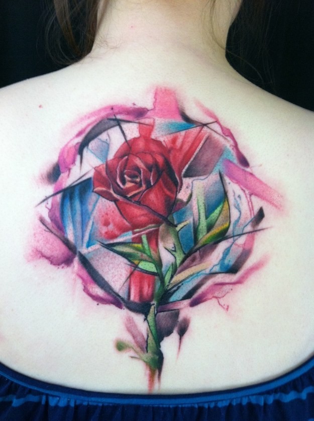 Colourful geometric rose tattoo on back