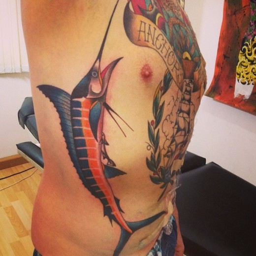 Coloured sword fish tattoo on ribs
