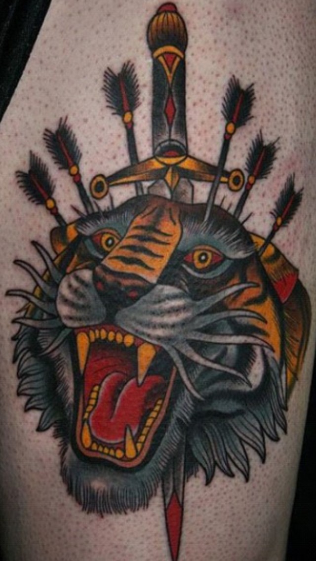 Coloured tiger head pierced by a dagger and arrows tattoo by Stefan Johnson-