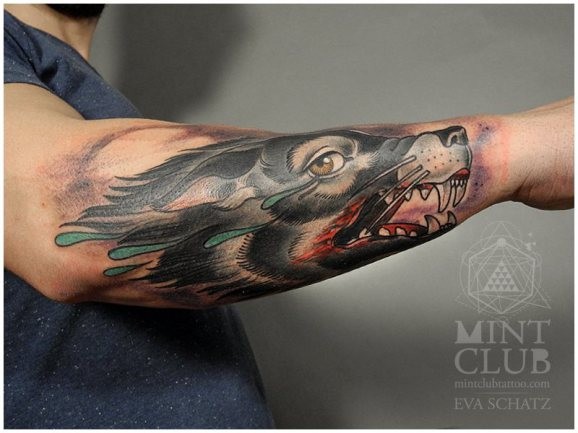 Coloured wolf with a bloody mouth forearm tattoo