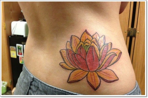 Colured lotus flower tattoo on ribs