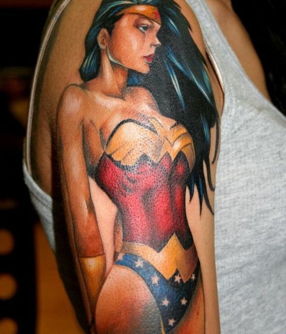 Comic books style colored detailed sexy Wounder-woman tattoo on upper arm