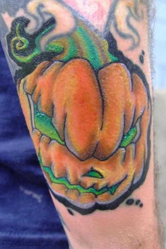 Comic books style multicolored little pumpkin on arm tattoo
