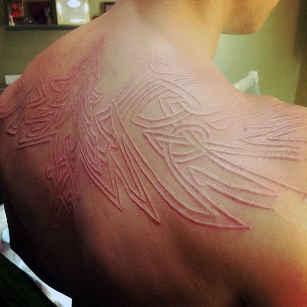 Cool 3D like white ink phoenix tattoo on upper back