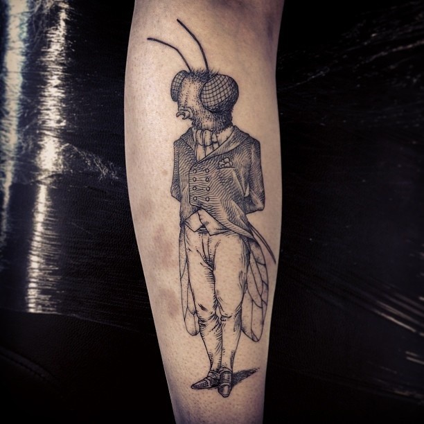 Cool awesome looking black ink human shaped insect tattoo on arm