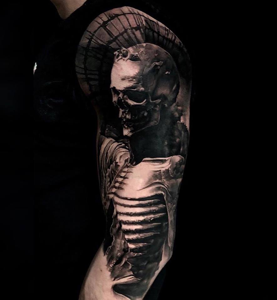 Cool black and white skeleton tattoo on shoulder