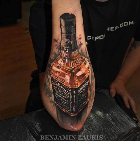Cool bottle of whiskey forearm tattoo by Laukis