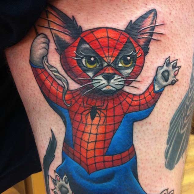 Cool cartoon like colored thigh tattoo of spider-cat