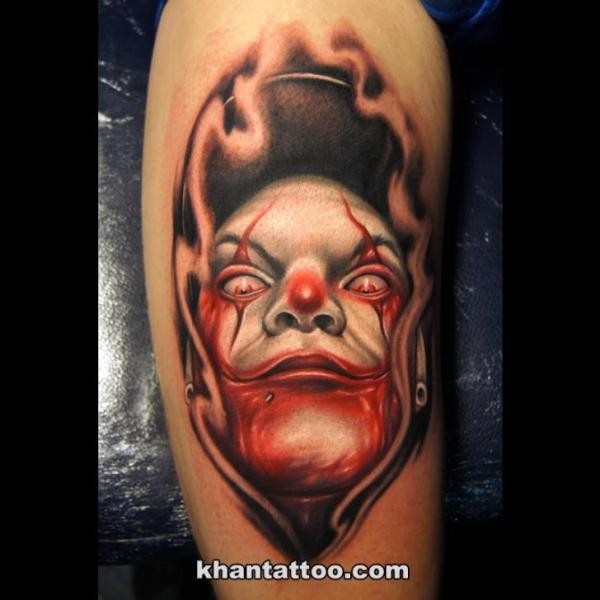 Cool cartoon style shoulder tattoo of maniac clown face