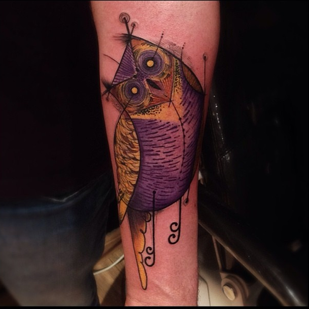 Cool colored arm tattoo of fantasy owl